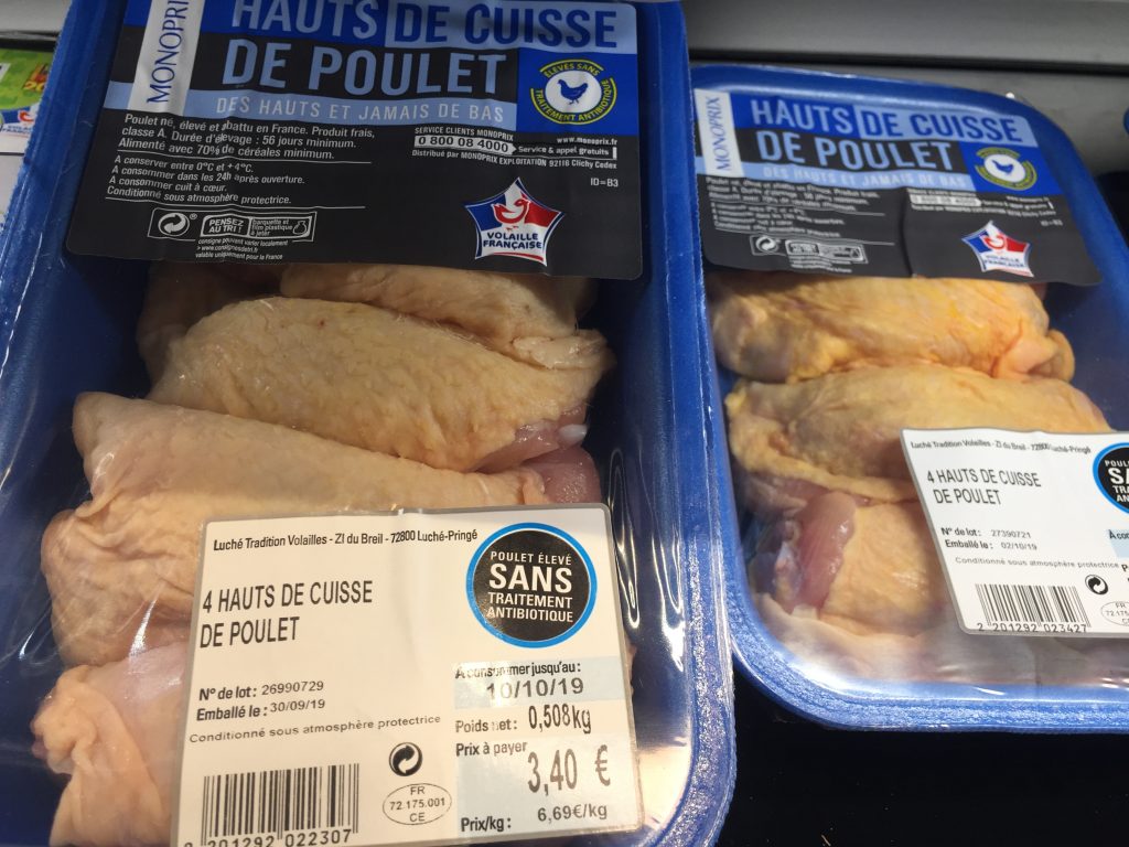 packages of chicken thighs in Paris grocery store