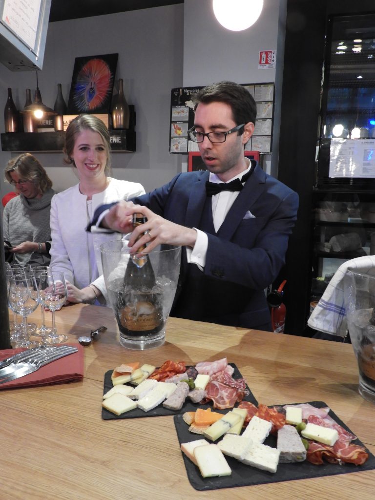 French wedding groom opening champagne