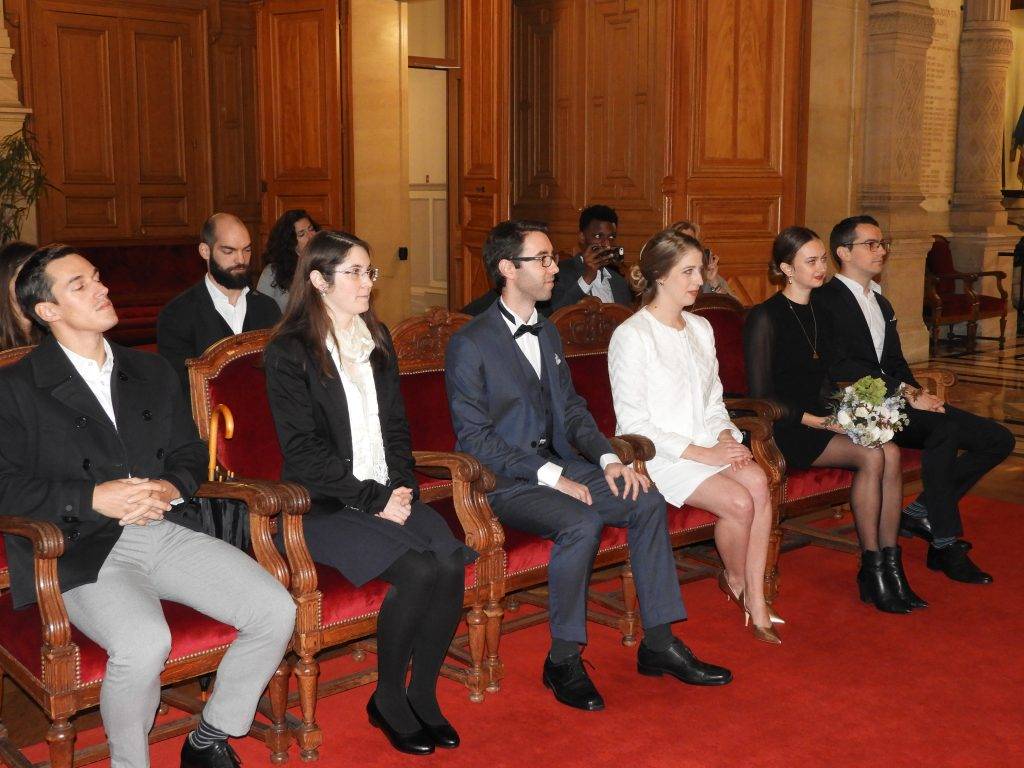 French civil ceremony witnesses sitting beside bride and groom