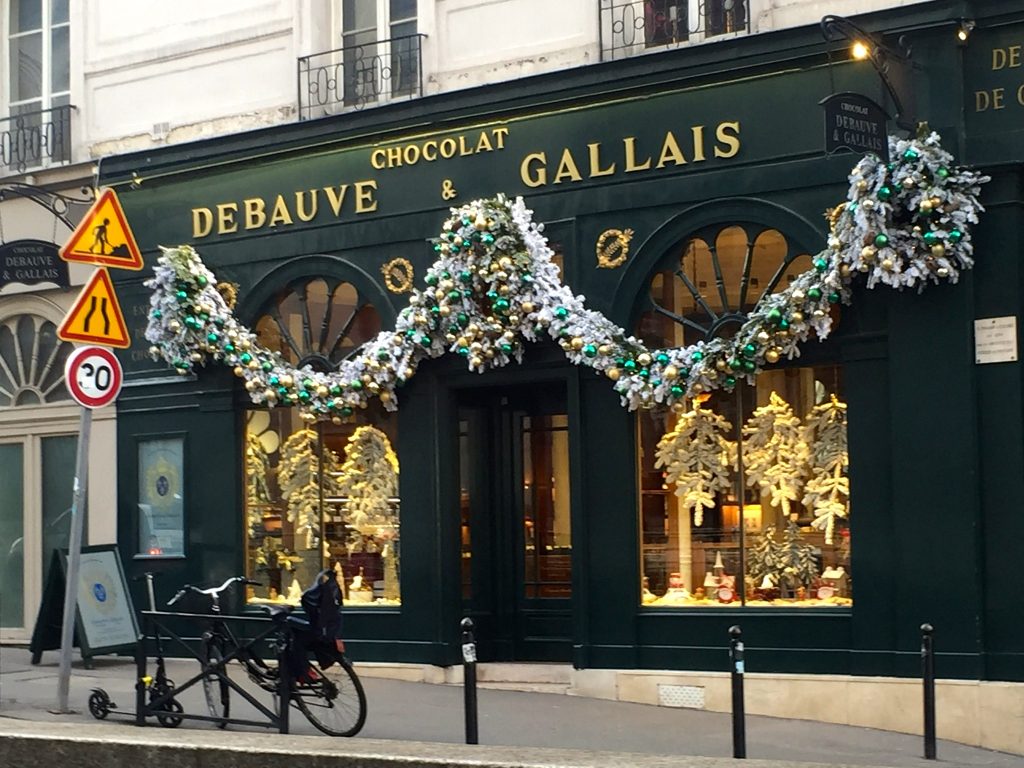 Christmas decorations draped outside of Paris store