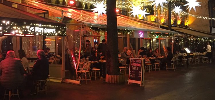 lights illuminated an outdoor terrasse in Paris