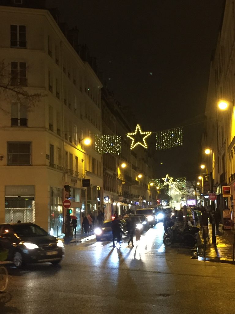 Christmas lights strung across Paris street