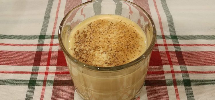 glass of eggnog with nutmeg sprinkled on top