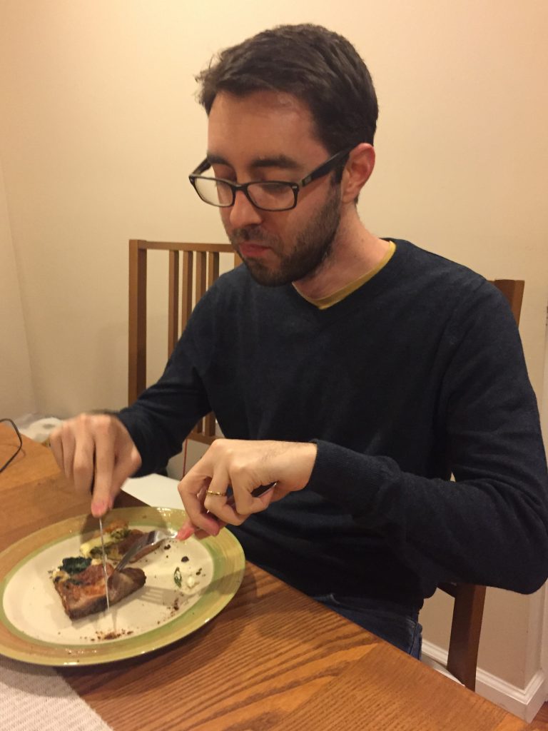 French man eating pizza with fork and knife