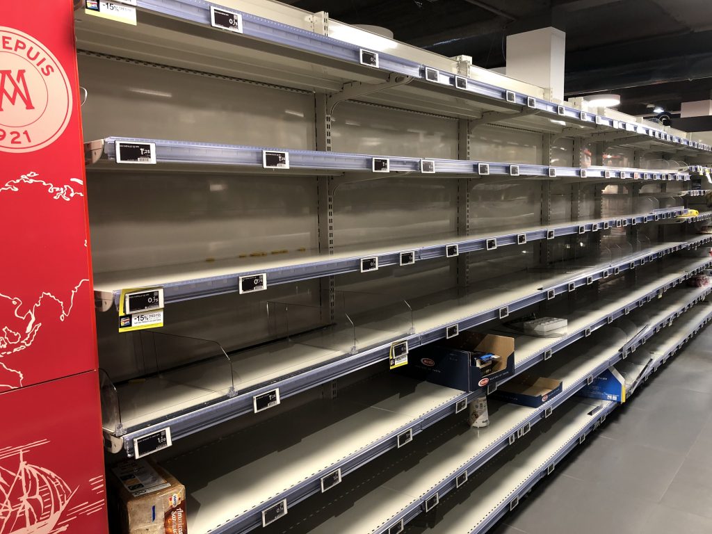 bare shelves in grocery store before confinement in Paris