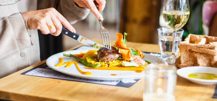 eating with fork in left hand, knife in right hand