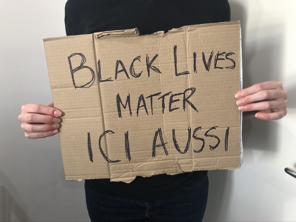 Sign on cardboard: Black Lives Matter Ici Aussi