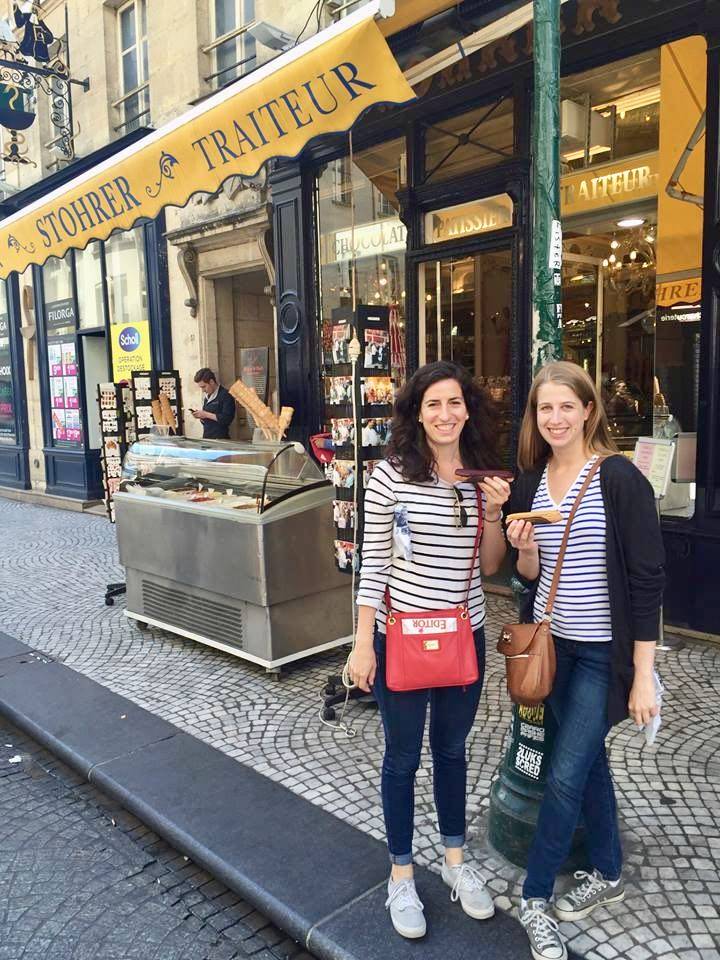 Joanna and Ellen eating éclairs outside of Stohrer in Paris