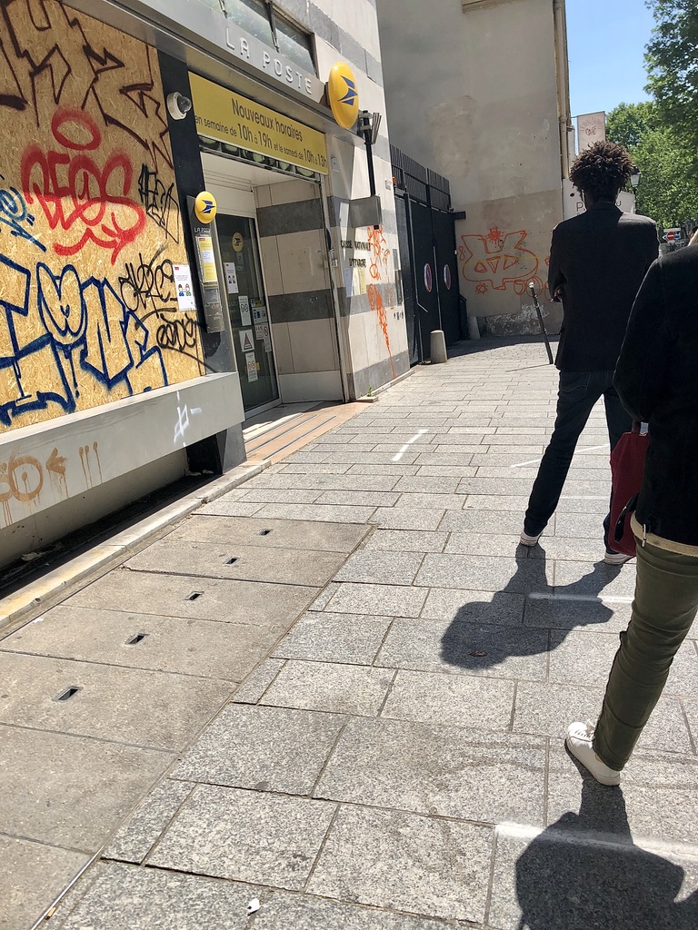 white lines on the ground for spacing and queue outside the post office