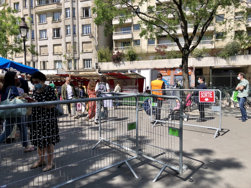 metal barriers surrounding an open air market in Paris to control crowds