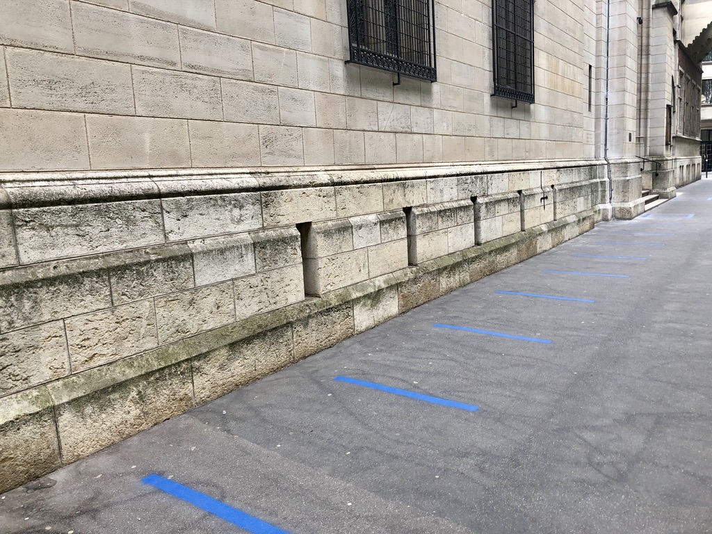 blue lines on the ground for spacing outside of a building in Paris