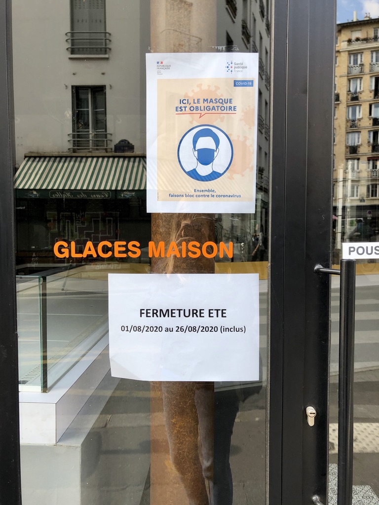 sign saying store is closed for the month of August in Paris