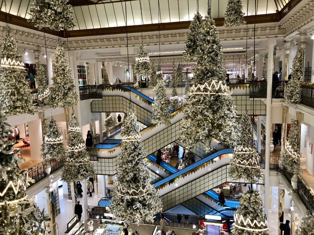 Le Bon Marché Paris department store at Christmas time with suspended trees and white lights 2020