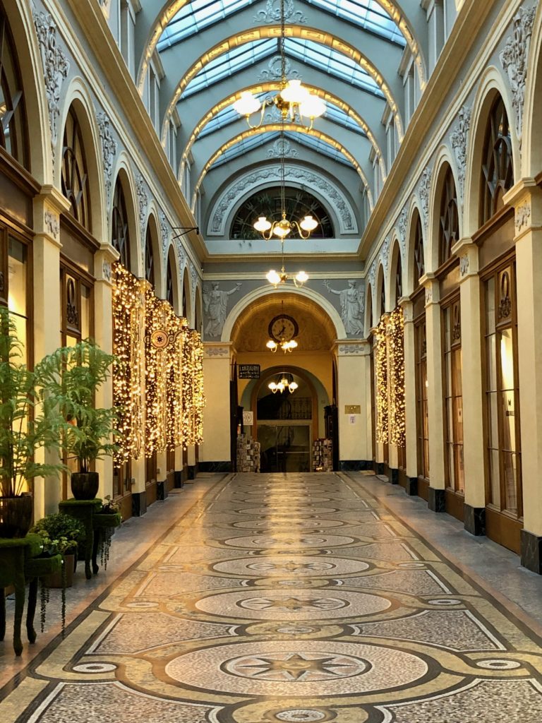 Inside Galerie Vivienne decorated with white lights Christmas 2020