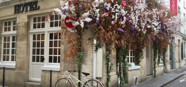 Hotel Jeanne d'Arc in the Marais decorated with flowers and a bike outside