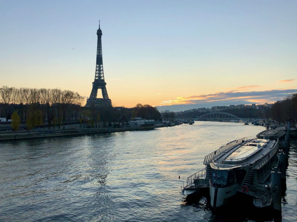 looking across the Seine river at the Eiffel tower at sunset