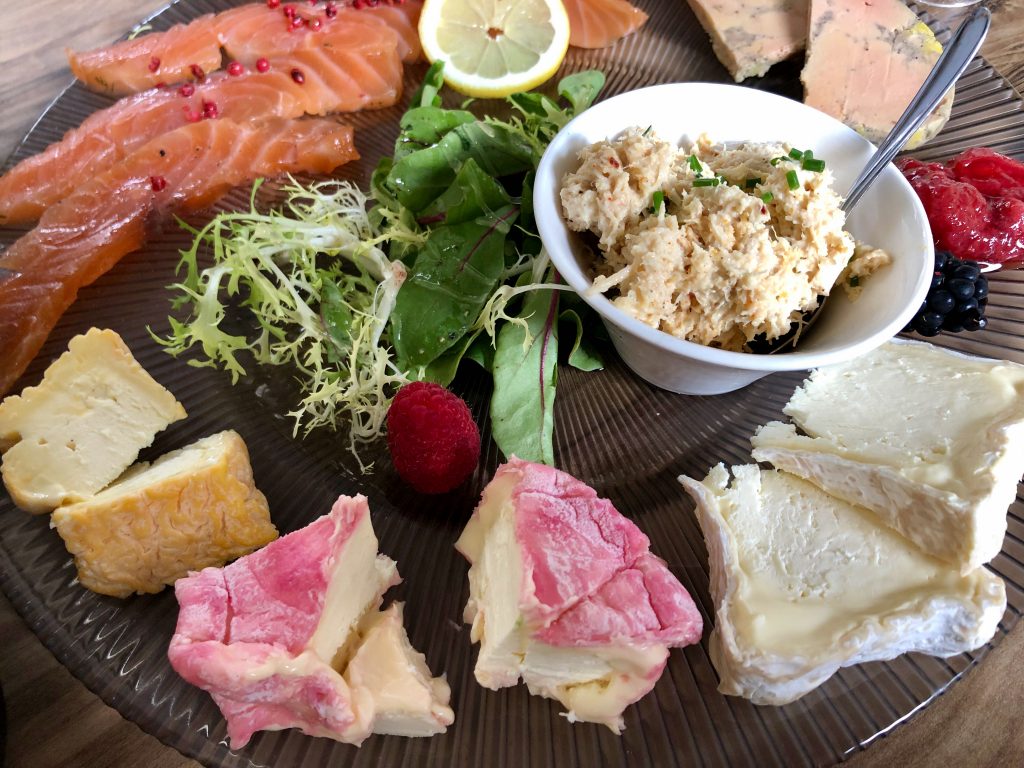 charcuterie board featuring le chaource, a regional cheese from the town of Chaource, France