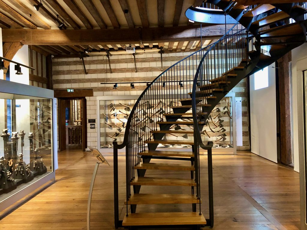 tools on display and staircase inside Maison de l’Outil et de la Pensée Ouvrière in Troyes, France