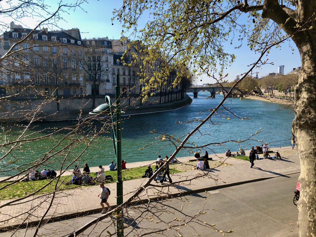 spring day, people sitting on the quai of the Seine River