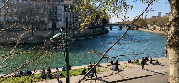 spring day, people sitting on the quai of the Seine River