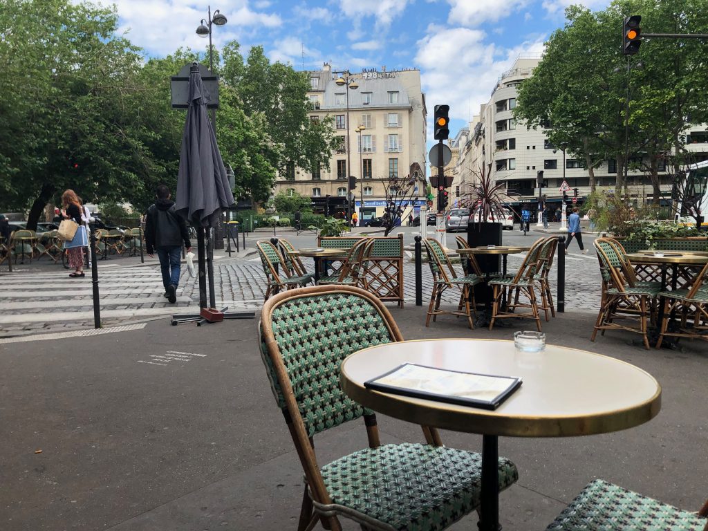 chairs and tables out on a café terrace in Paris
