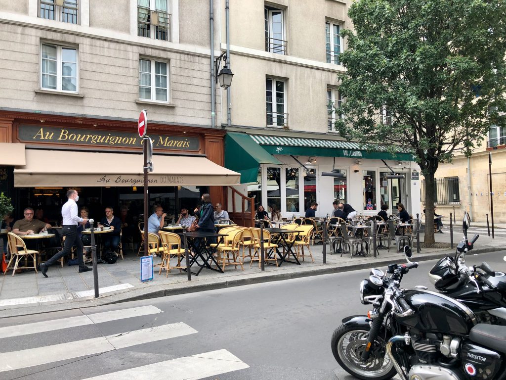 outdoor dining at two restaurants in the Marais