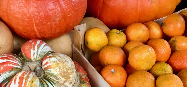 bright orange pumpkins, red kuri squash, clementines
