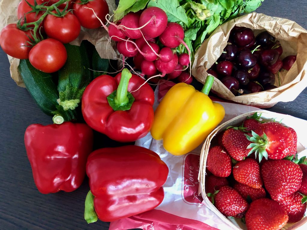 fruits and vegetables fresh from the French open-air market: tomatoes, zucchini, peppers, cherries, radishes, strawberries