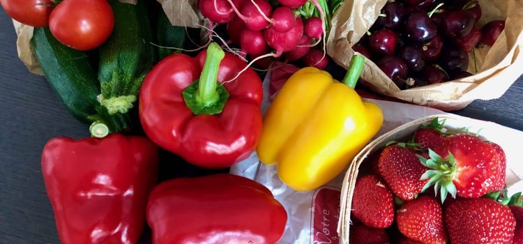 fruits and vegetables fresh from the French open-air market: tomatoes, zucchini, peppers, cherries, radishes, strawberries