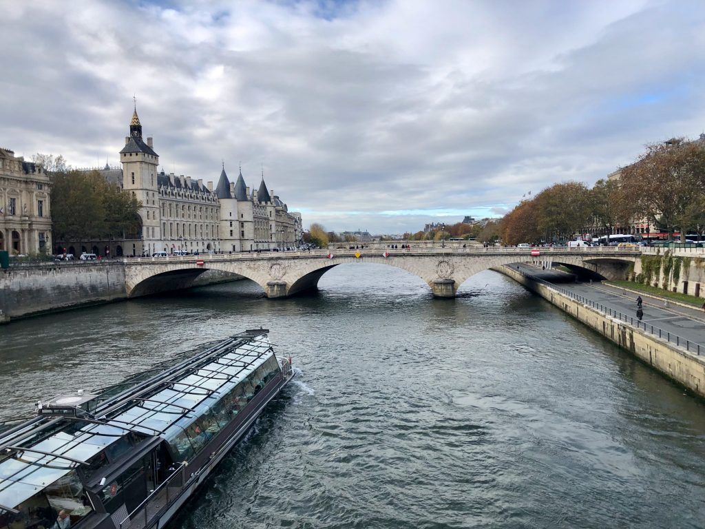 tourist boat on the Seine river with the Conciergerie in the background