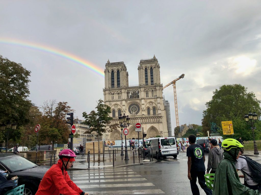 rainbow in Paris hitting the Notre-Dame Cathedral