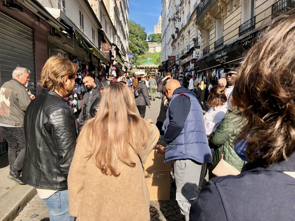 the crowded Rue de Steinkerque in Paris, leading up to Sacre Coeur