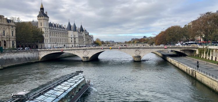 tourist boat on the Seine river with the Conciergerie in the background