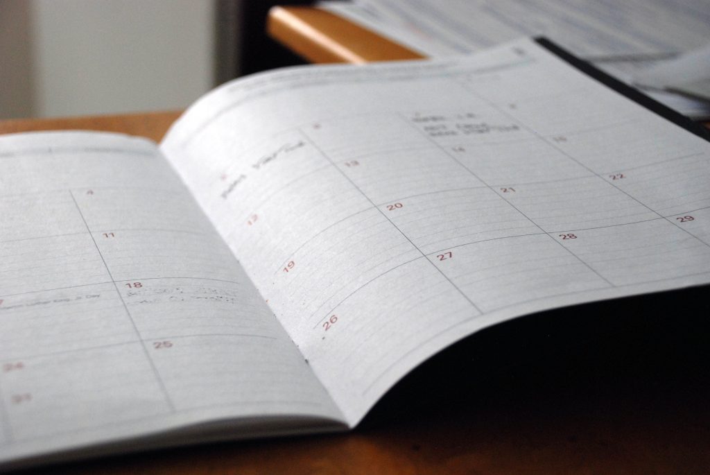 paper calendar diary, sitting open on a desk