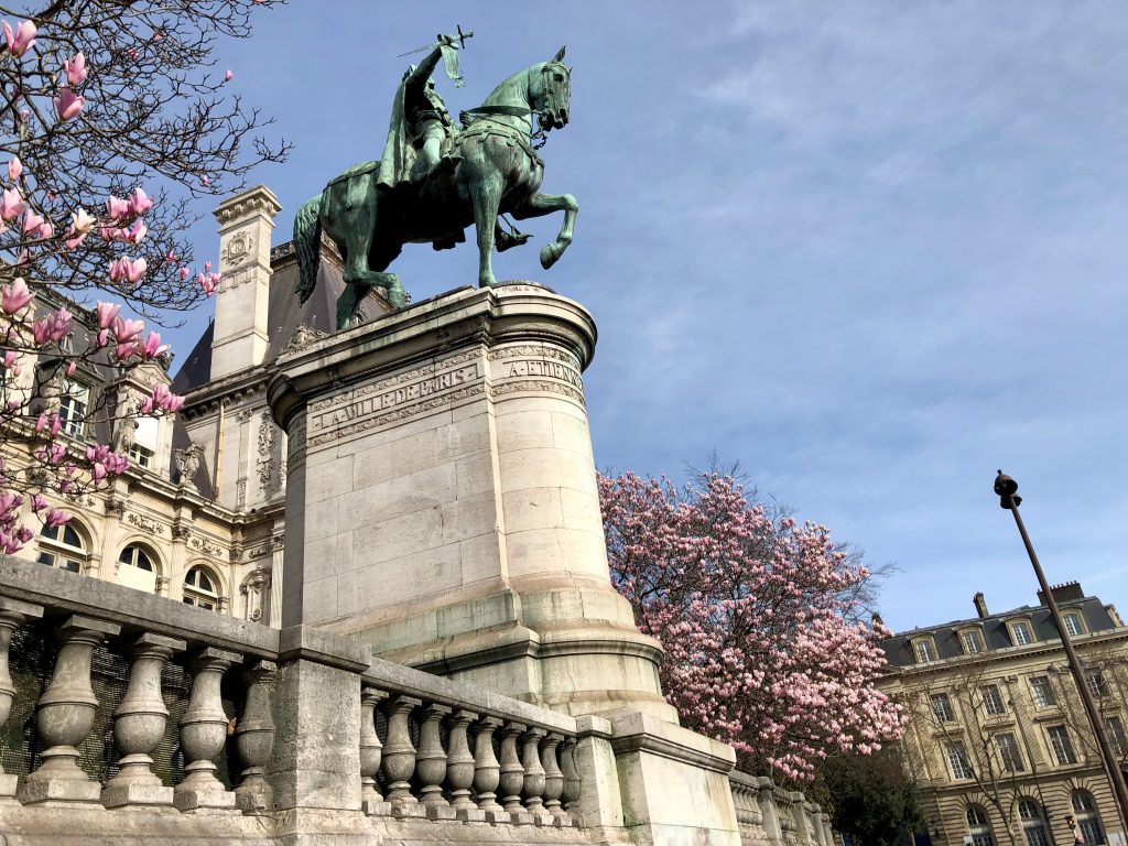 twin magnolia trees blooming on either side of the Statue d'Étienne Marcel, next to the Paris Hôtel de ville