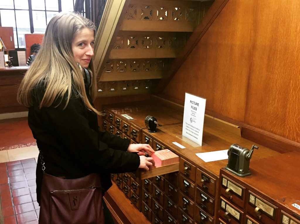 woman looking through a card index in the New York Public Library in NYC