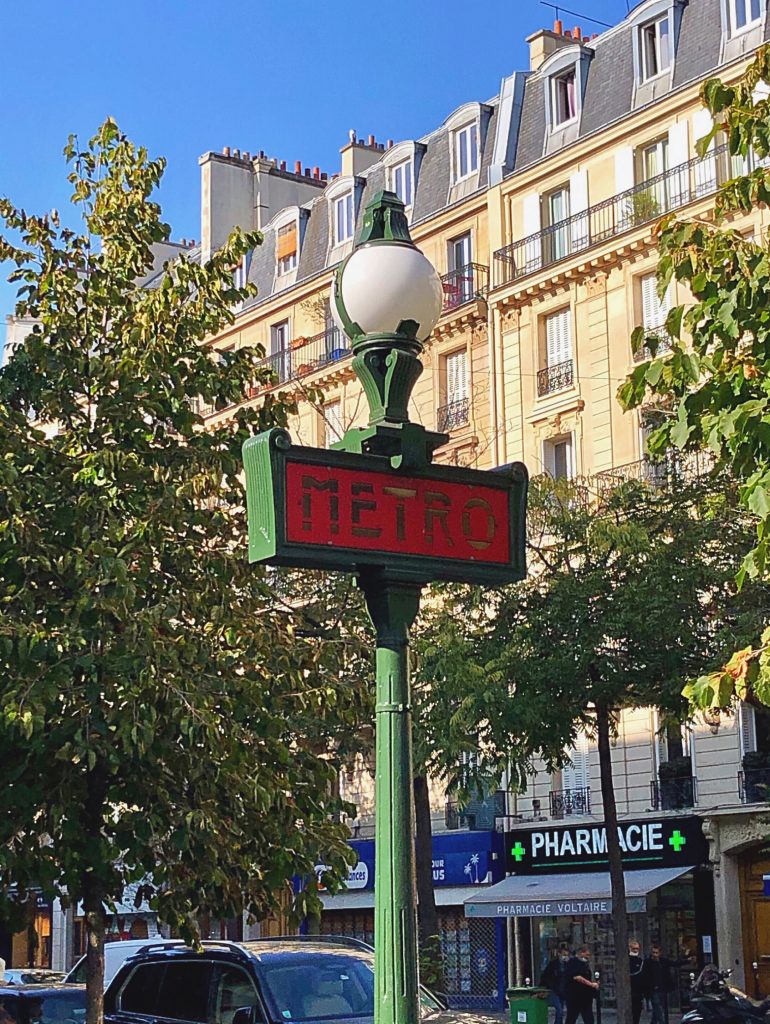 Green and red Metro sign in Paris