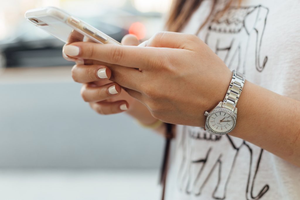 close up of woman's hands holding a smartphone