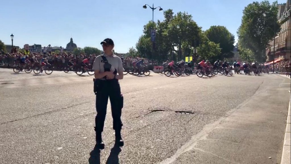 peloton racing through Paris for the Tour de France 2021