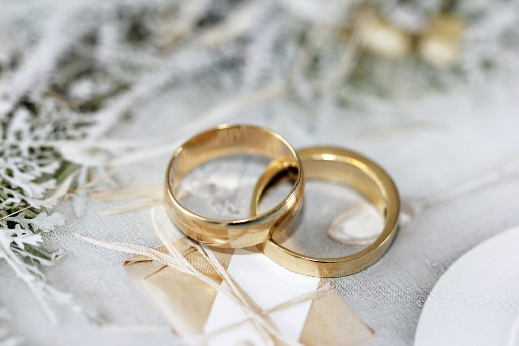 gold wedding bands laying together on a textured background