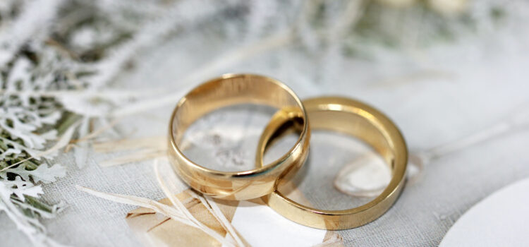 gold wedding bands laying together on a textured background