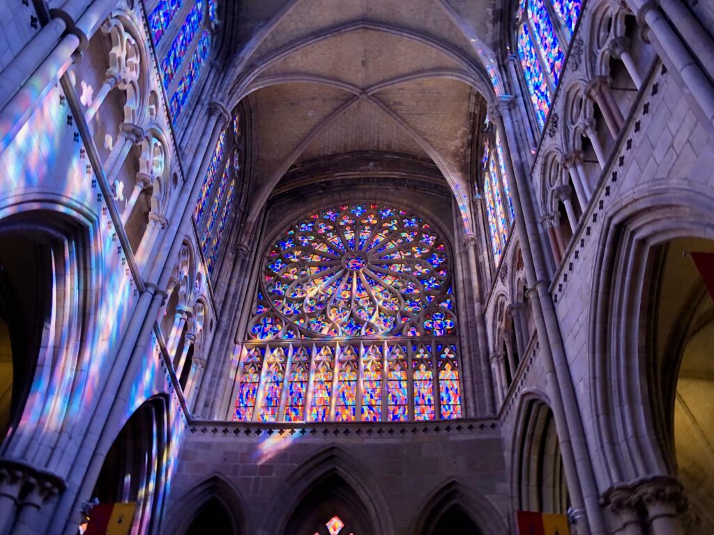 stained glass windows inside Saint Vincent Cathedral in Saint-Malo, rainbow reflections on the wall