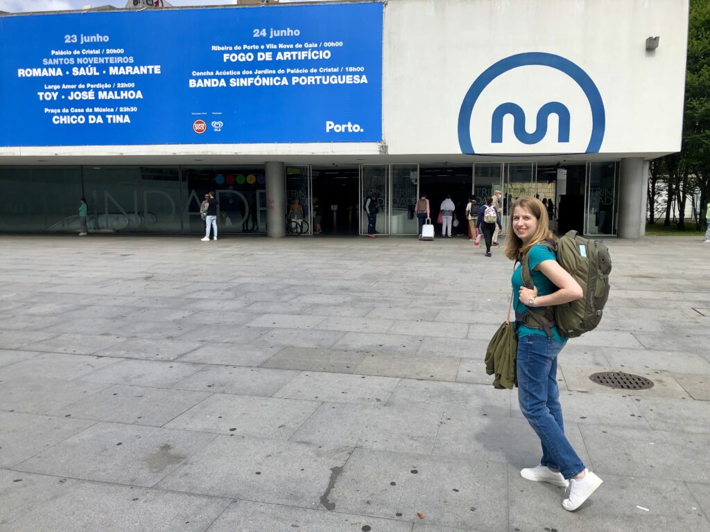 women with Osprey Fairview 40 backpack standing in front of a metro station in Porto, Portugal