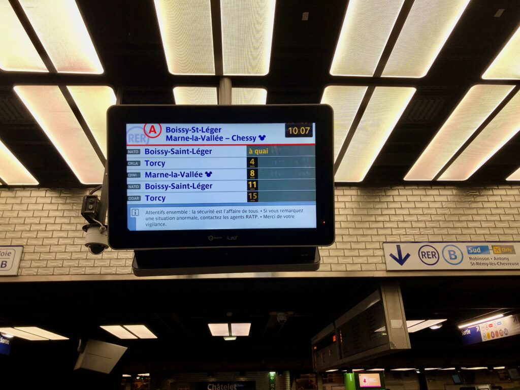 on the platform for the RER A at the Châtelet Les Halles metro stop, looking up at the screen which indicates we are going in the direction of Chessy/Disneyland Paris
