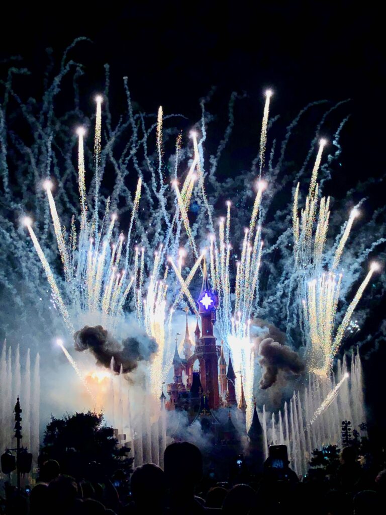 fireworks shooting up all around the Sleeping Beauty Castle during the Disney Illuminations show in Paris