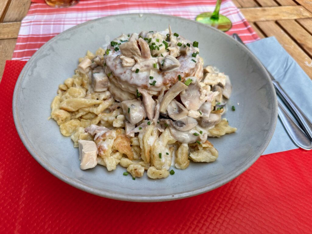 Bouchée a la reine, a hollowed puff pastry filled with a mix of diced veal, chicken, and mushrooms in a creamy gravy. Served on top of spätzle, a traditional Alsatian noodle.