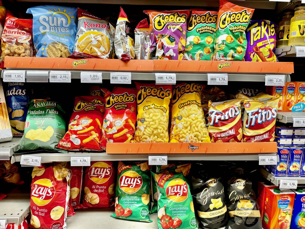 The chip aisle in a grocery store in Madrid, Spain. Cheetos, Frito's, Lay's, and other brands can be seen in various flavors.