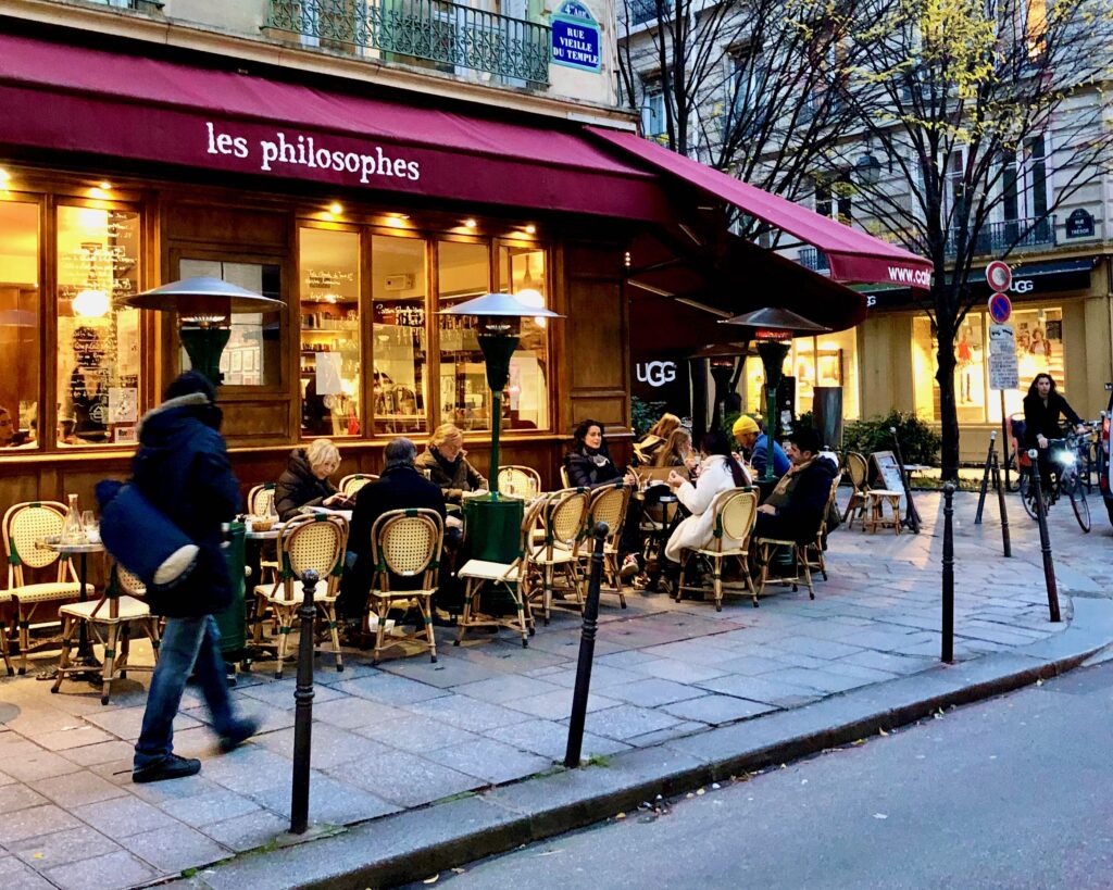 Heating lamps warming up patrons in the outdoor seating area of a Paris café before they were banned in 2022.