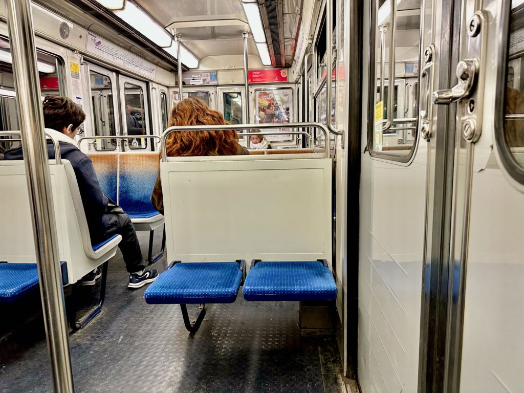 Two unoccupied folding seats on the Paris metro, line 12