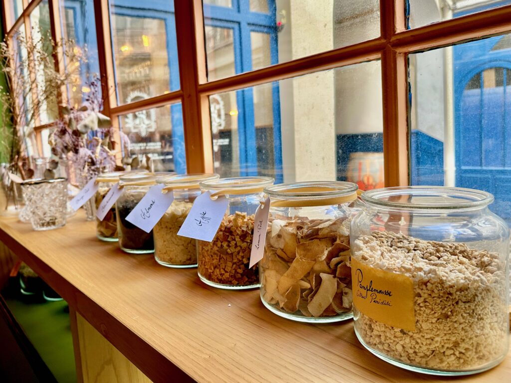 Row of botanicals in glass jars at a make your own gin workshop in Paris